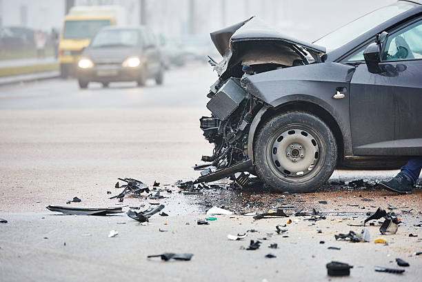 Two damaged cars on a city street after a collision